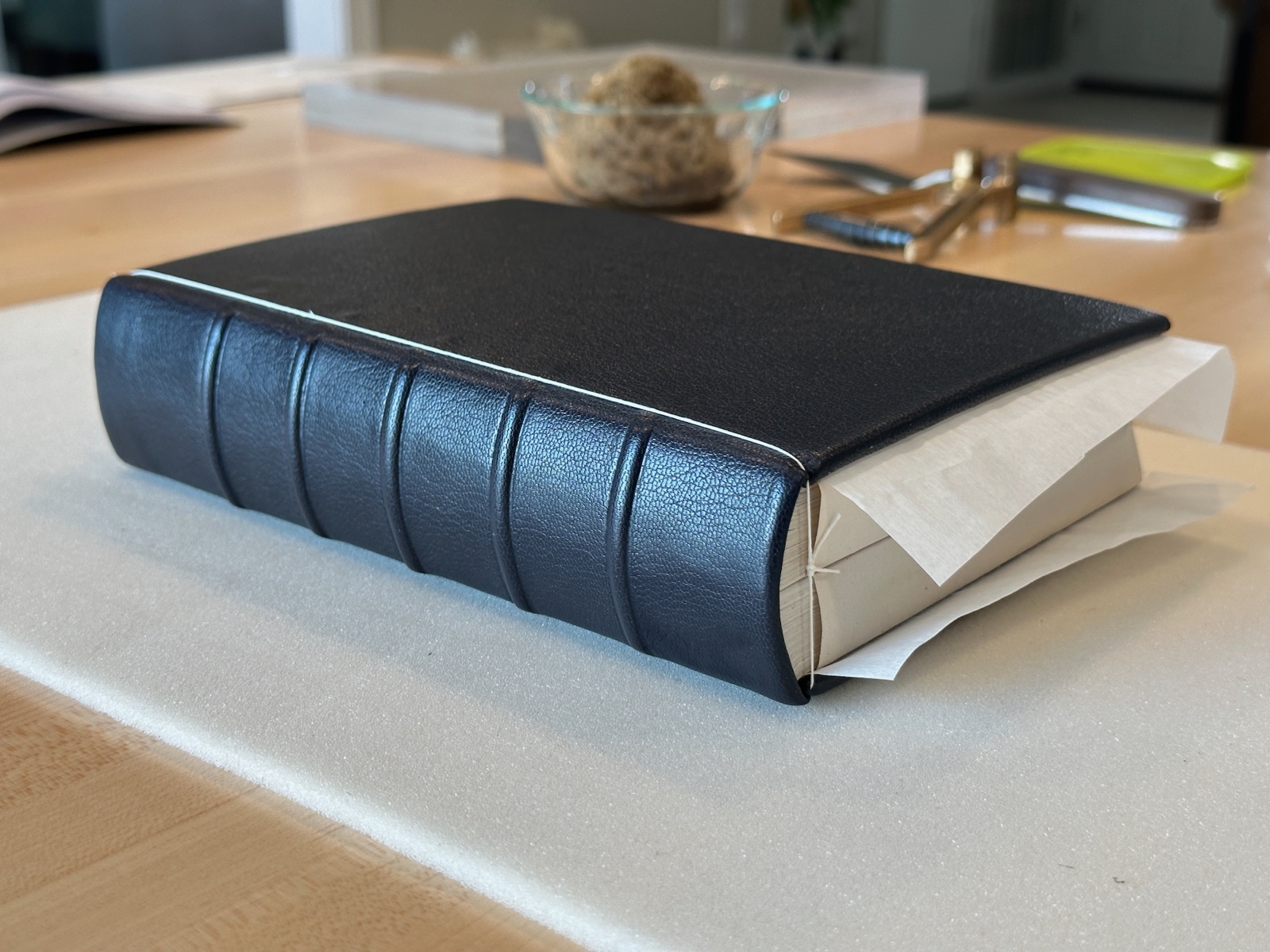 a full black leather bound book laying flat on a table