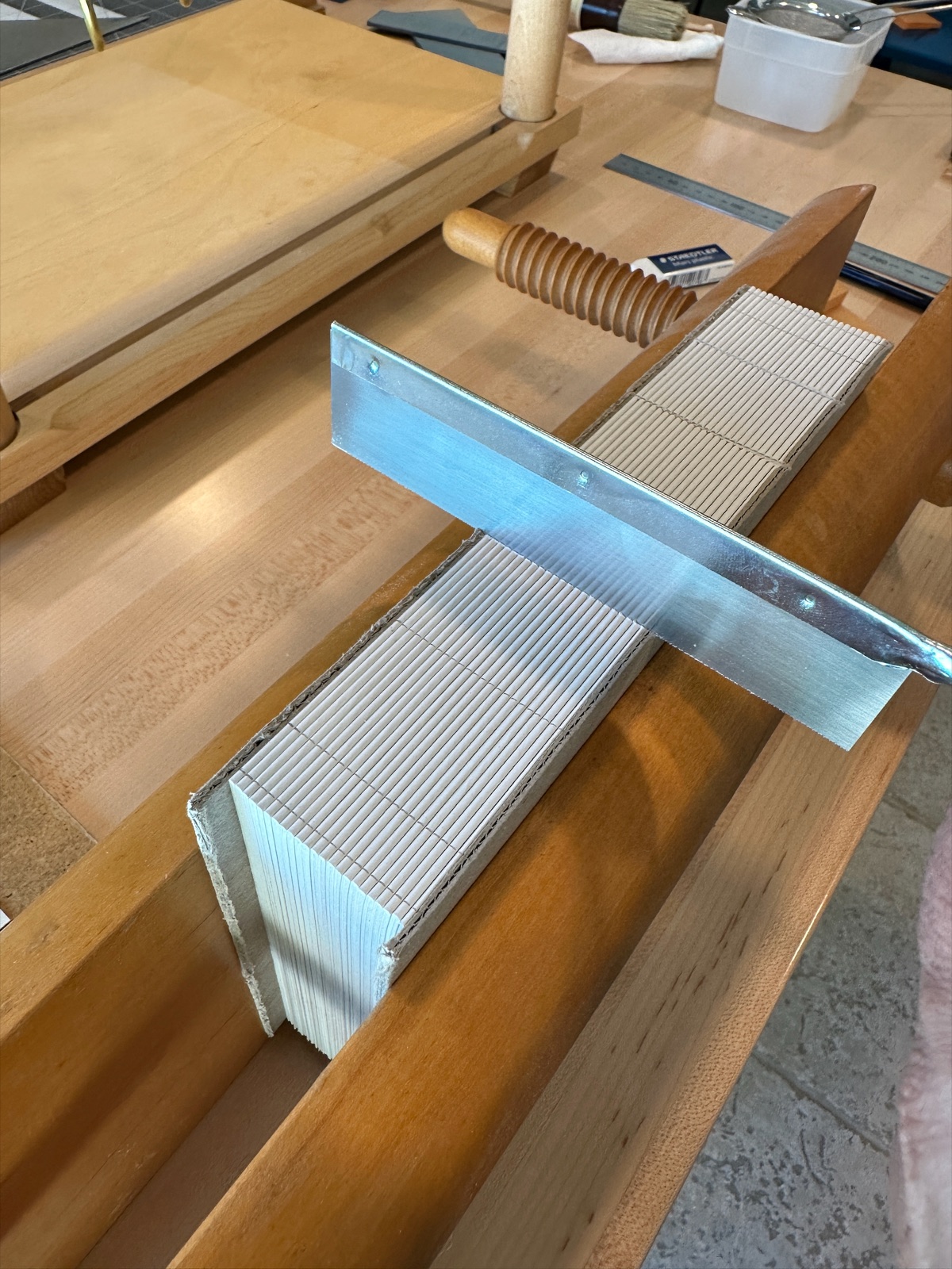 a japanese saw cutting the flat spine of a text block