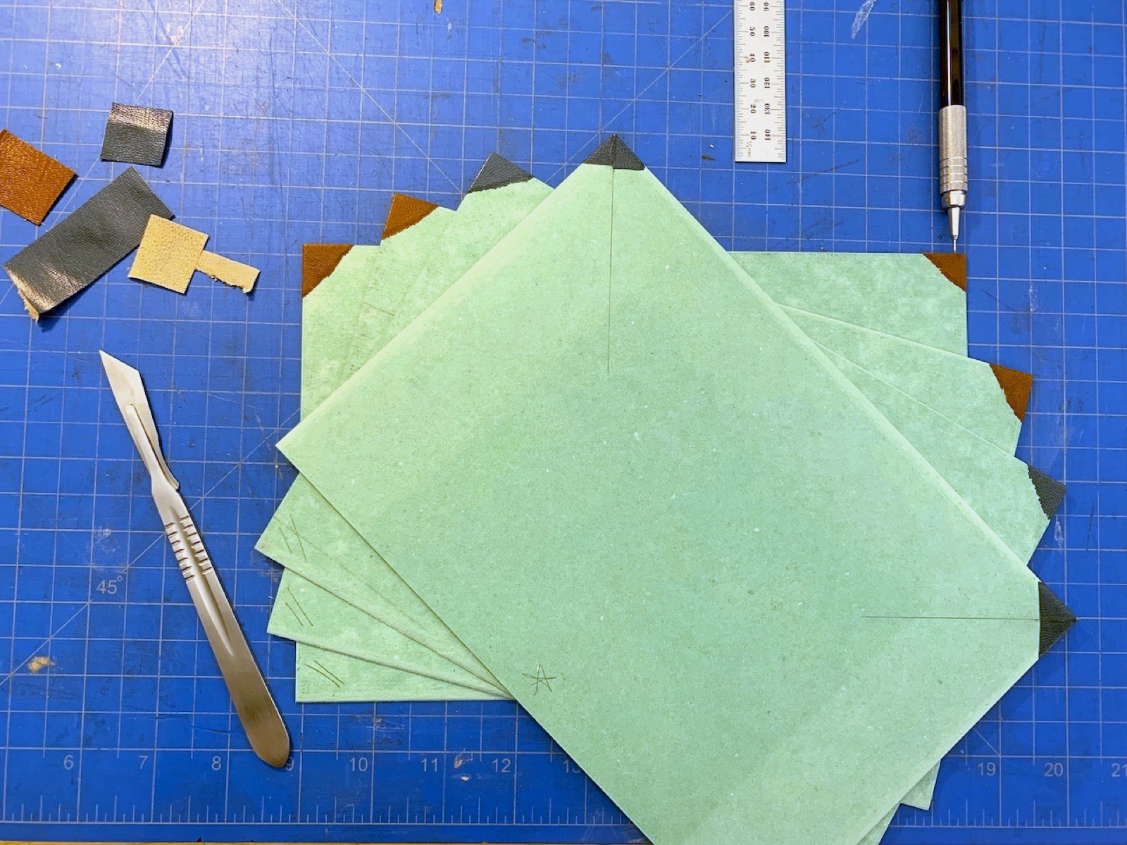 green mill boards on a crafting table revealing corners with small leather tips