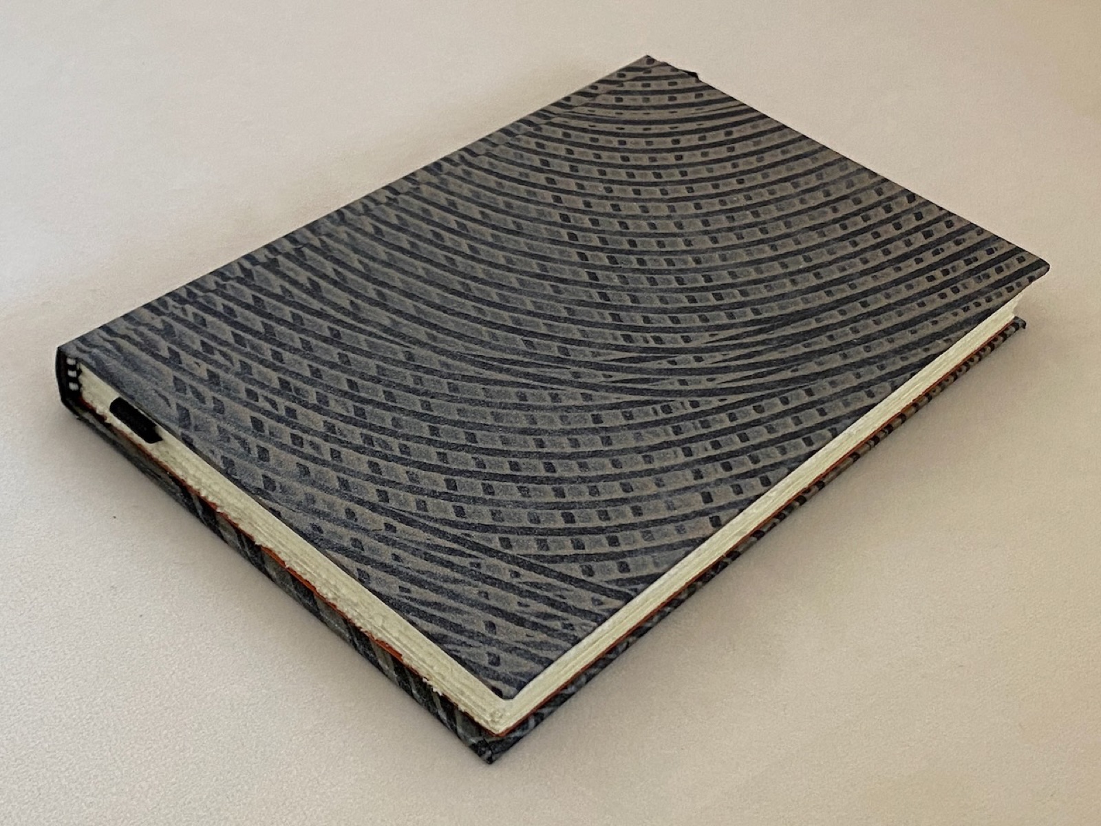 A black binding with a wave-textured cover.