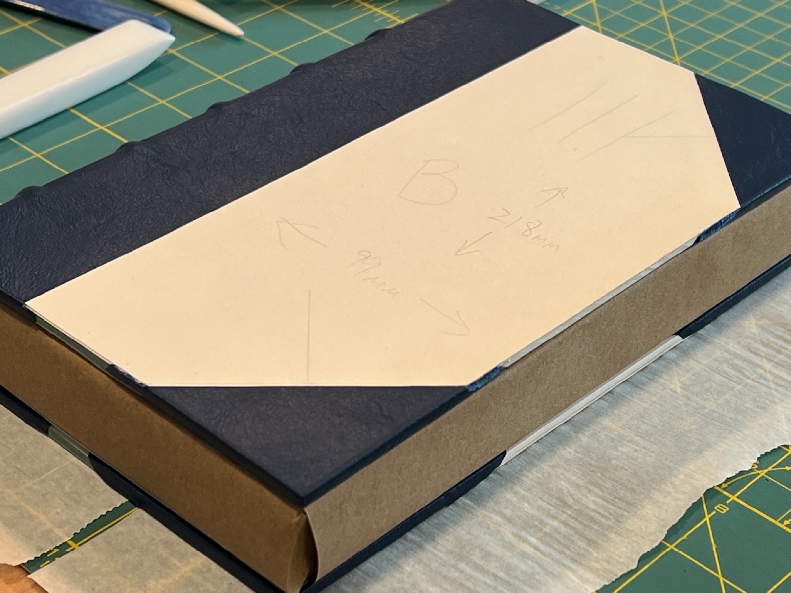 front of a book showing an almost complete half leather binding, ready for the paper inserts