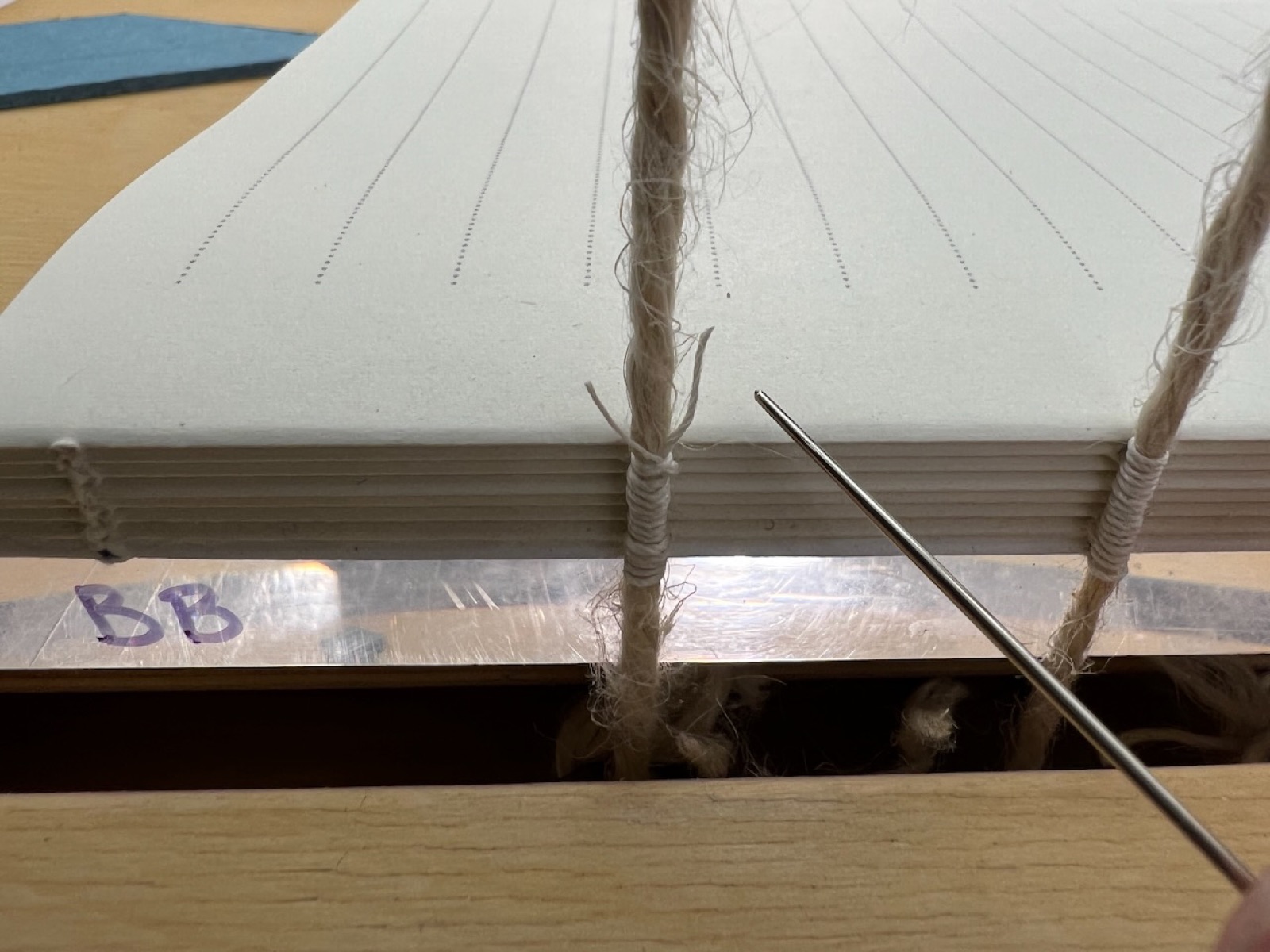 starting to sew signatures together on a sewing frame
