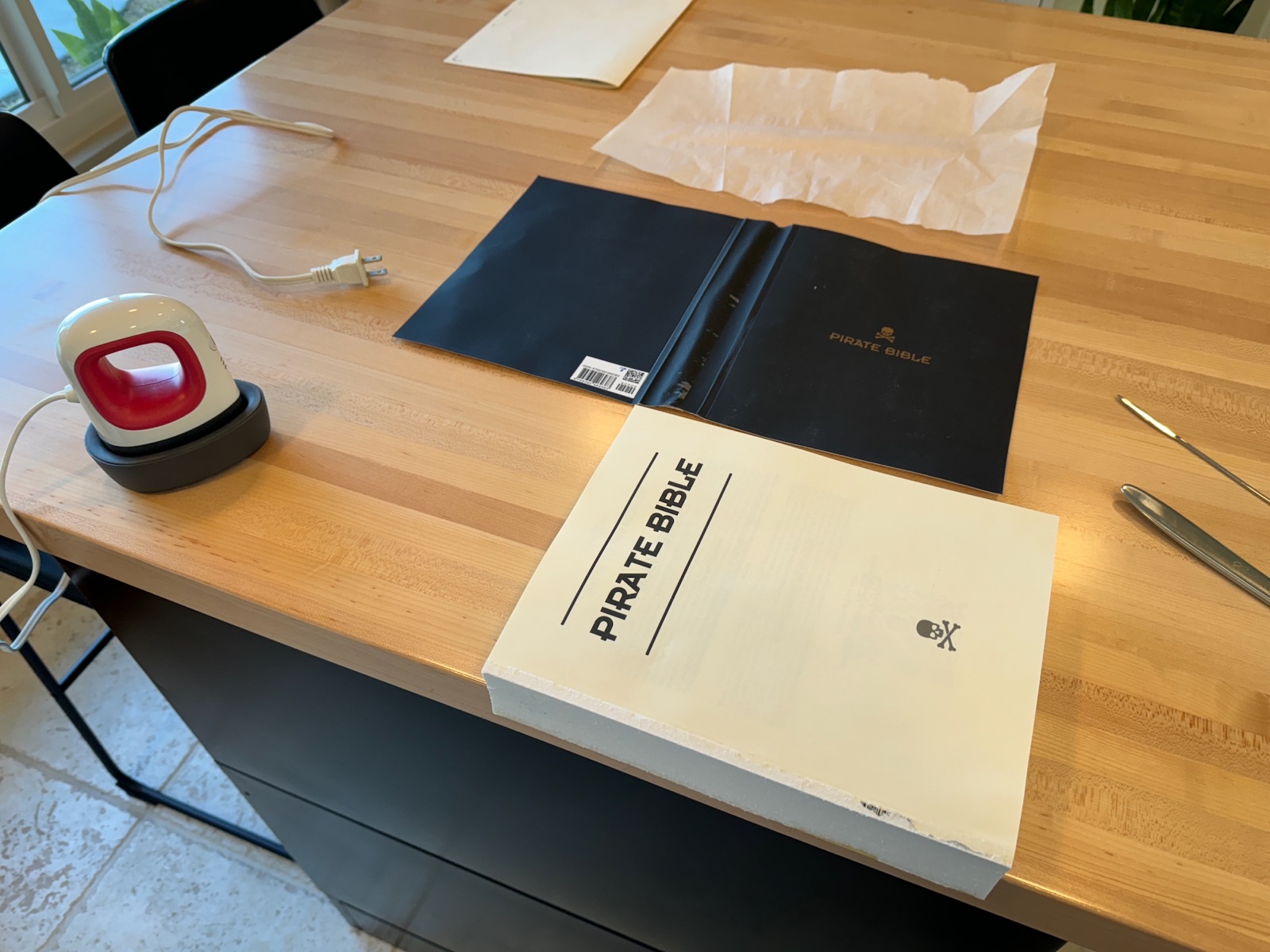 book with removed black paper cover sitting on table