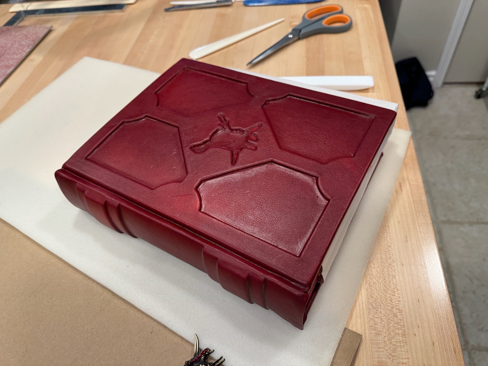 pirate book with full red leather sitting on table