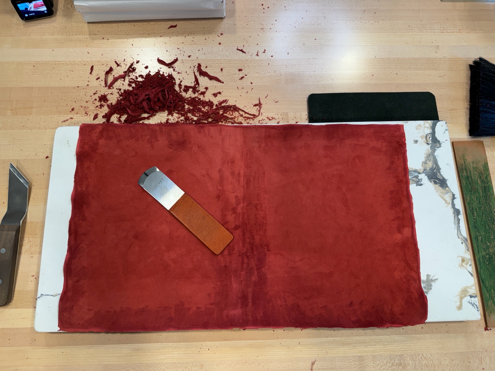 red leather being pared with paring knife