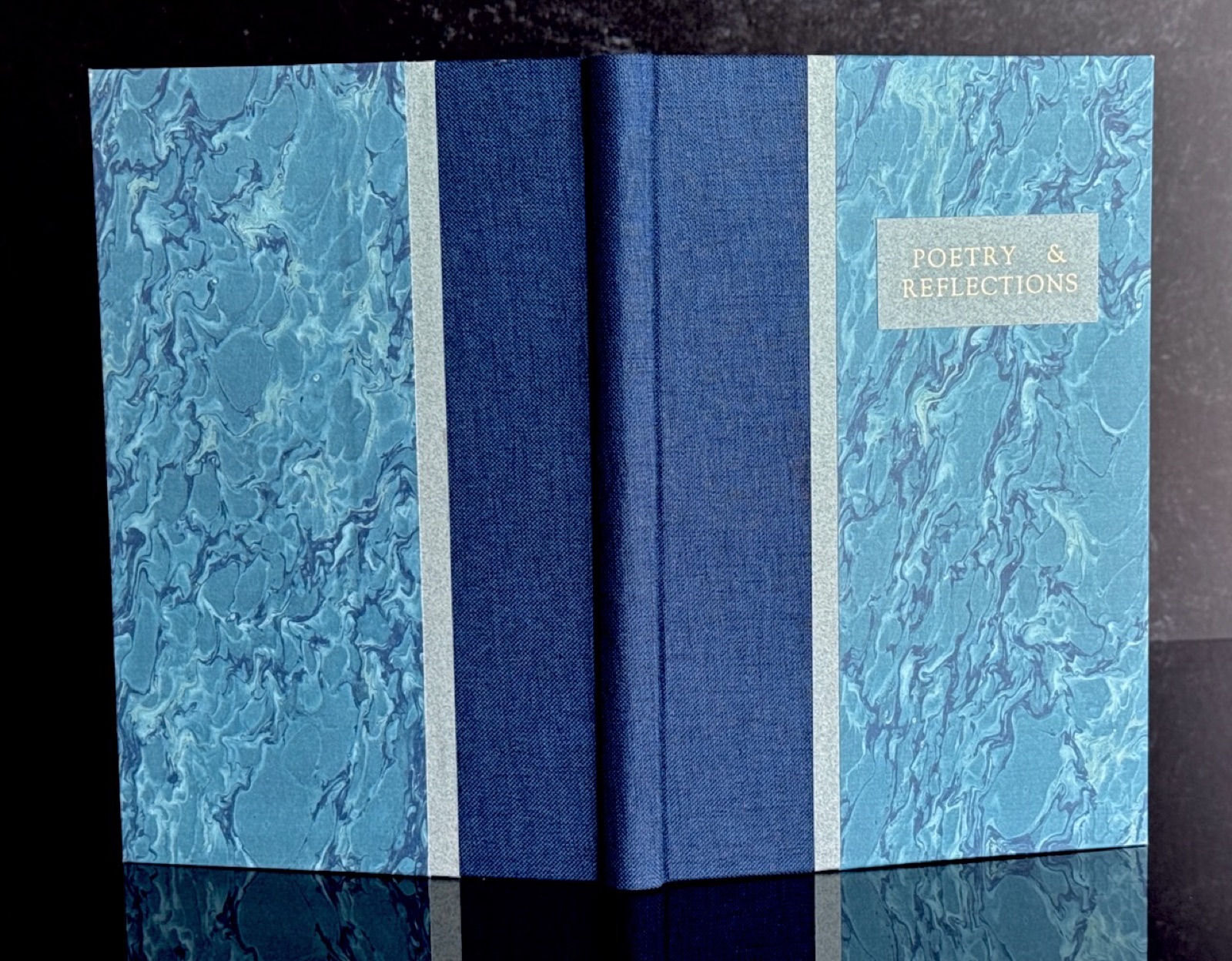 Case binding • blue cloth and marbled paper with type-tool-stamped title.