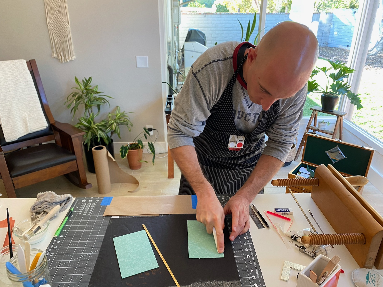 a person adhering green boards to black paper