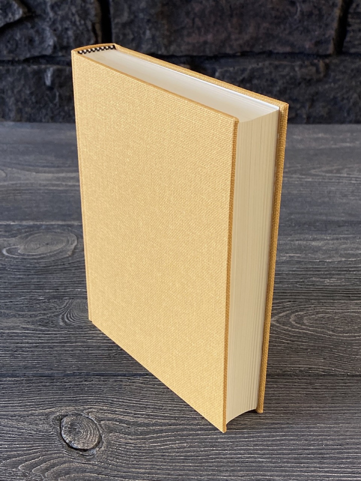 A yellow cloth binding standing on a grey background.