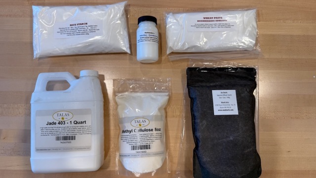 PVA, methyl cellulose, and paste supplies arranged on a bench.