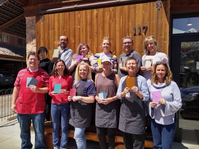 Bookbinding classmates holding their finished books outside the American Academy of Bookbinding in Telluride.