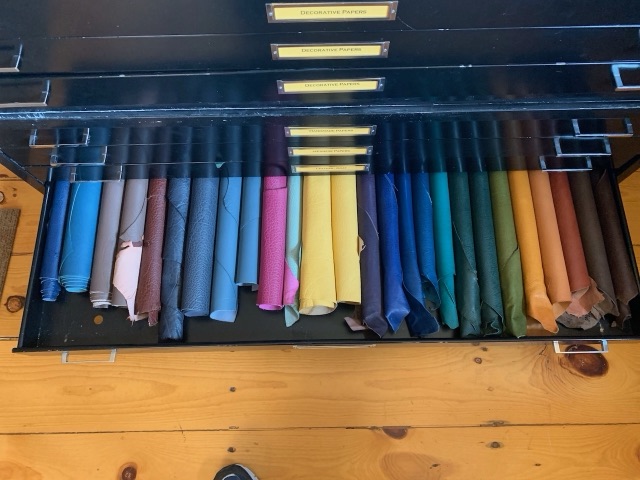 A flat file drawer of decorative and Japanese papers in many colors.