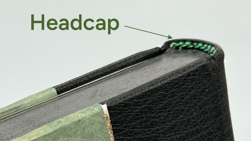 A leather headcap worked over the endband at the head of the spine.