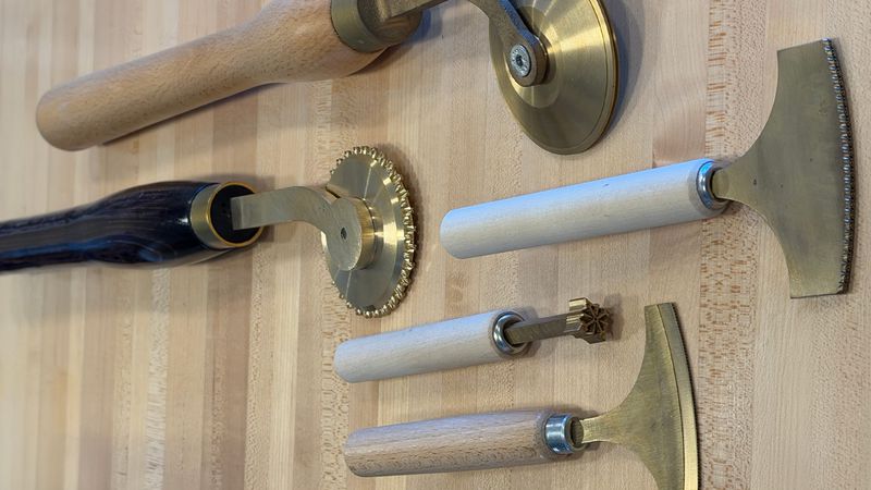 Brass finishing tools used to tool and decorate covers.